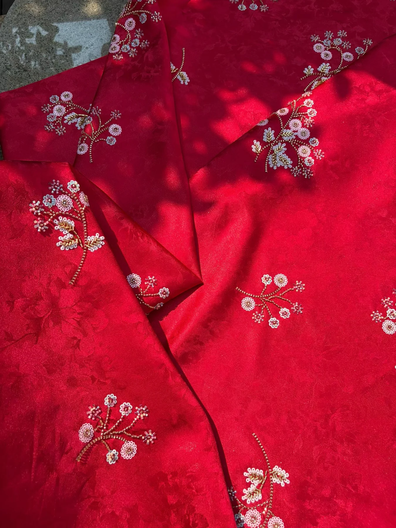 Red embellished embroidered fabric